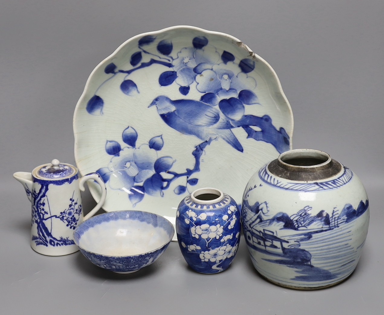 A Japanese Edo period blue and white dish, a Chinese Prunus blossom jar, late 19th century, a provincial blue and white jar and other items, dish 31 cms diameter